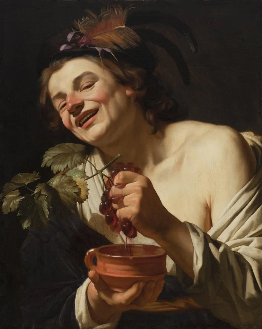 Lachende jonge man die druiven drukt - Gerrit van Honthorst